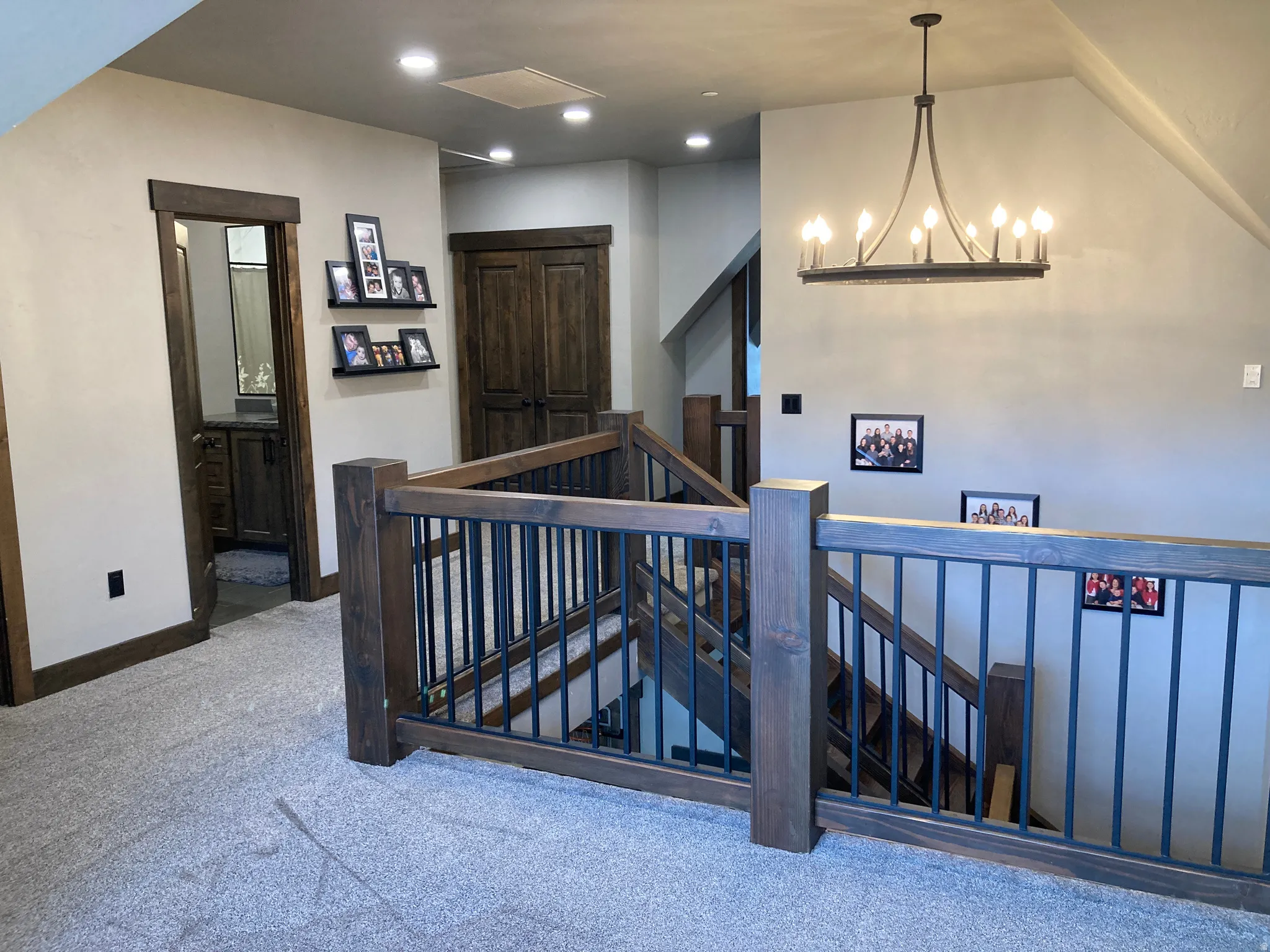 Staircase featuring carpet flooring and a chandelier