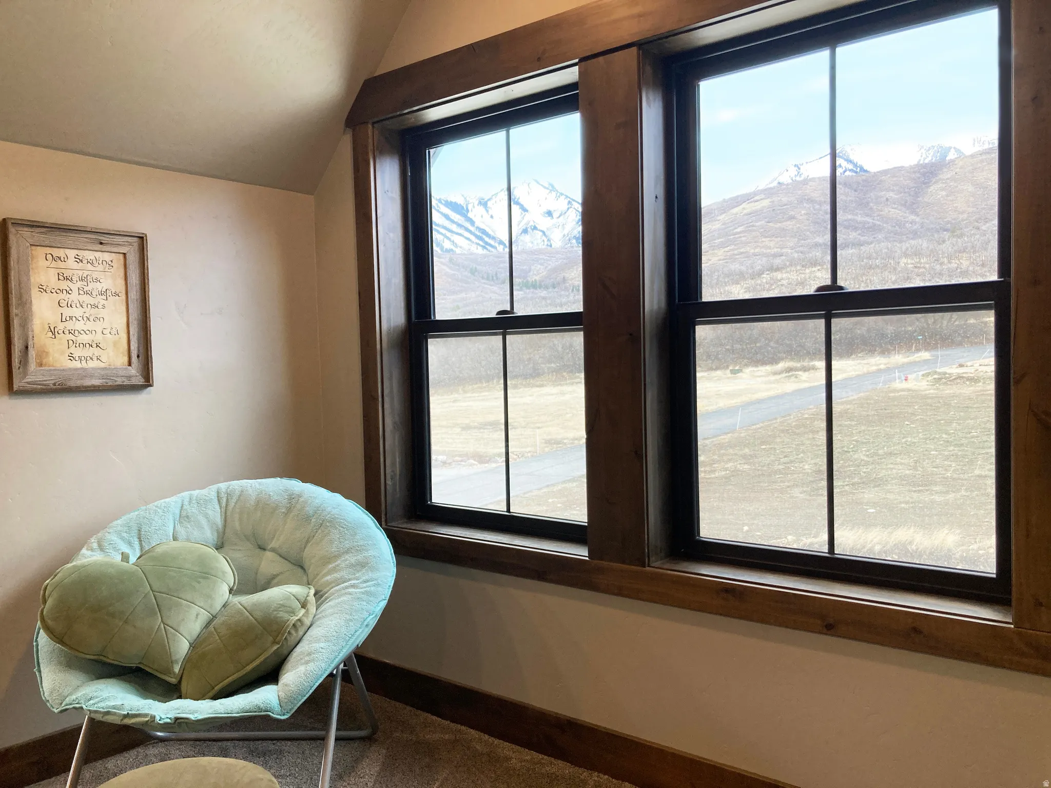 Living area featuring lofted ceiling and dark colored carpet
