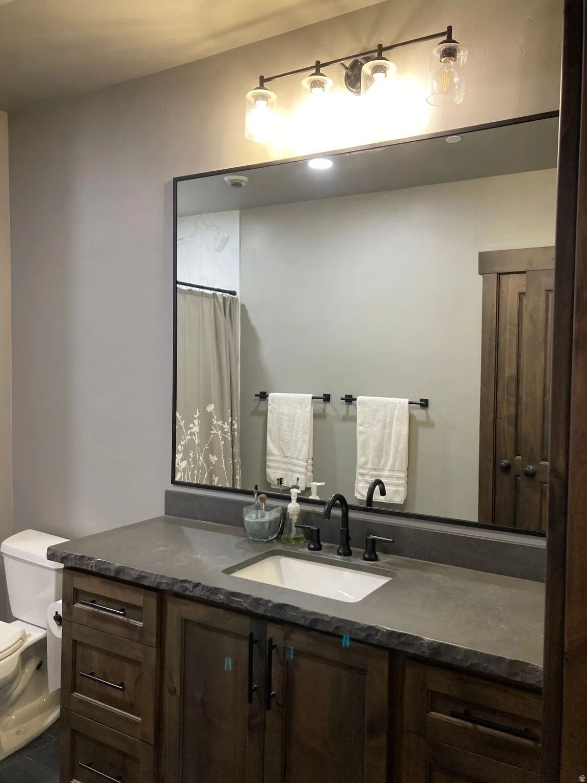 Bathroom with vanity and curtained shower