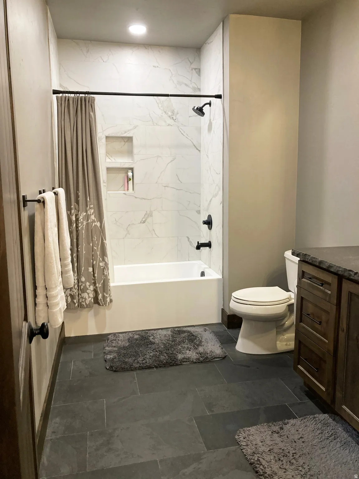 Full bath featuring vanity and shower / bathtub combination with curtain