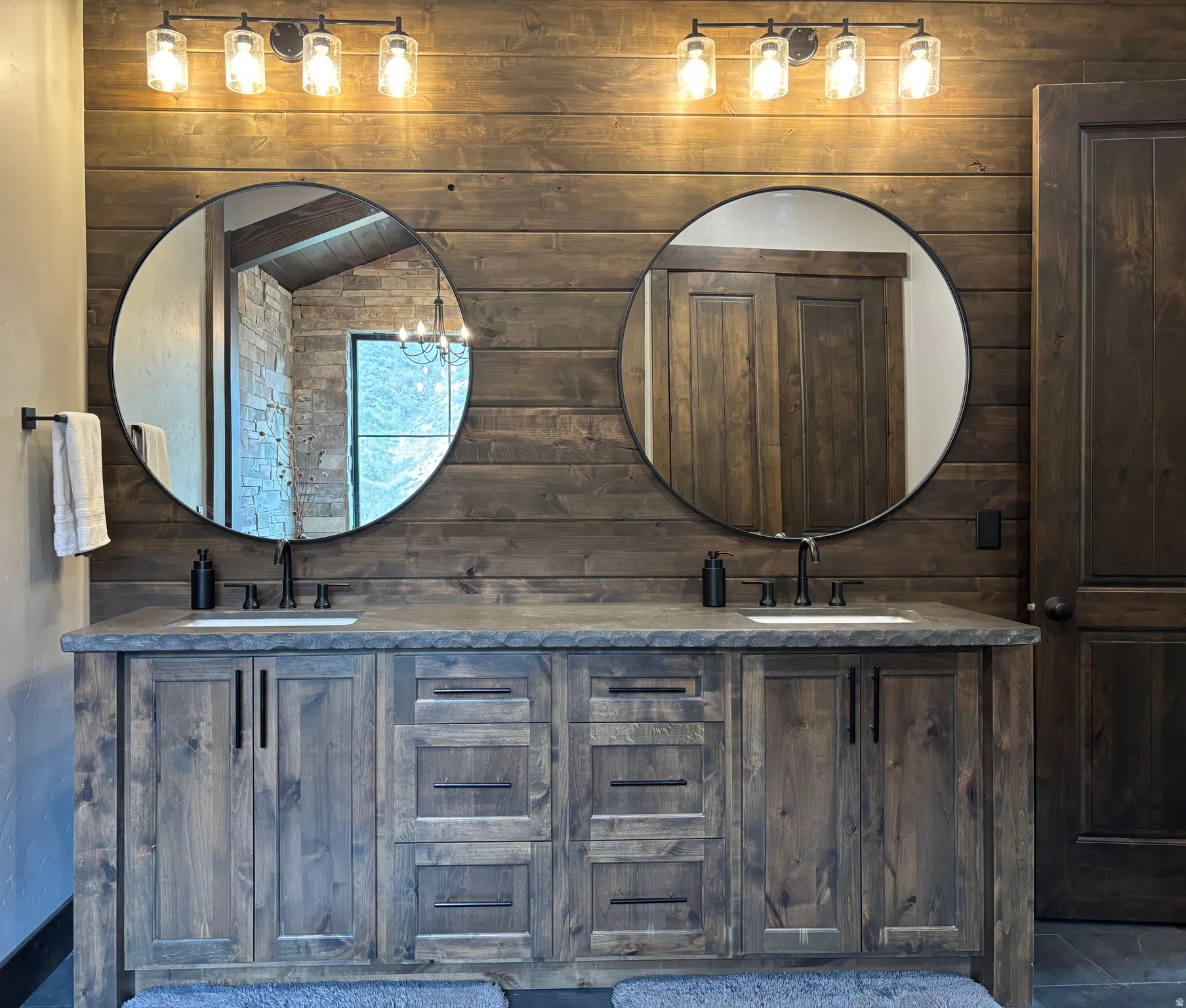Full bath with wooden walls and double vanity