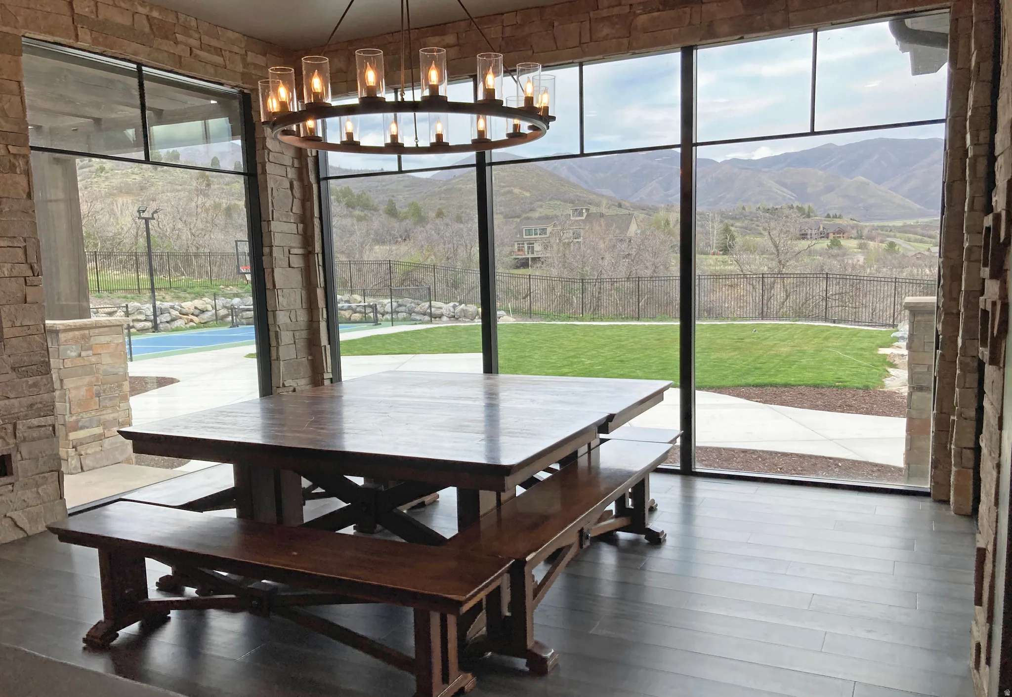 Dining room with healthy amount of natural light, a mountain view, wood-type flooring, and hanging lights