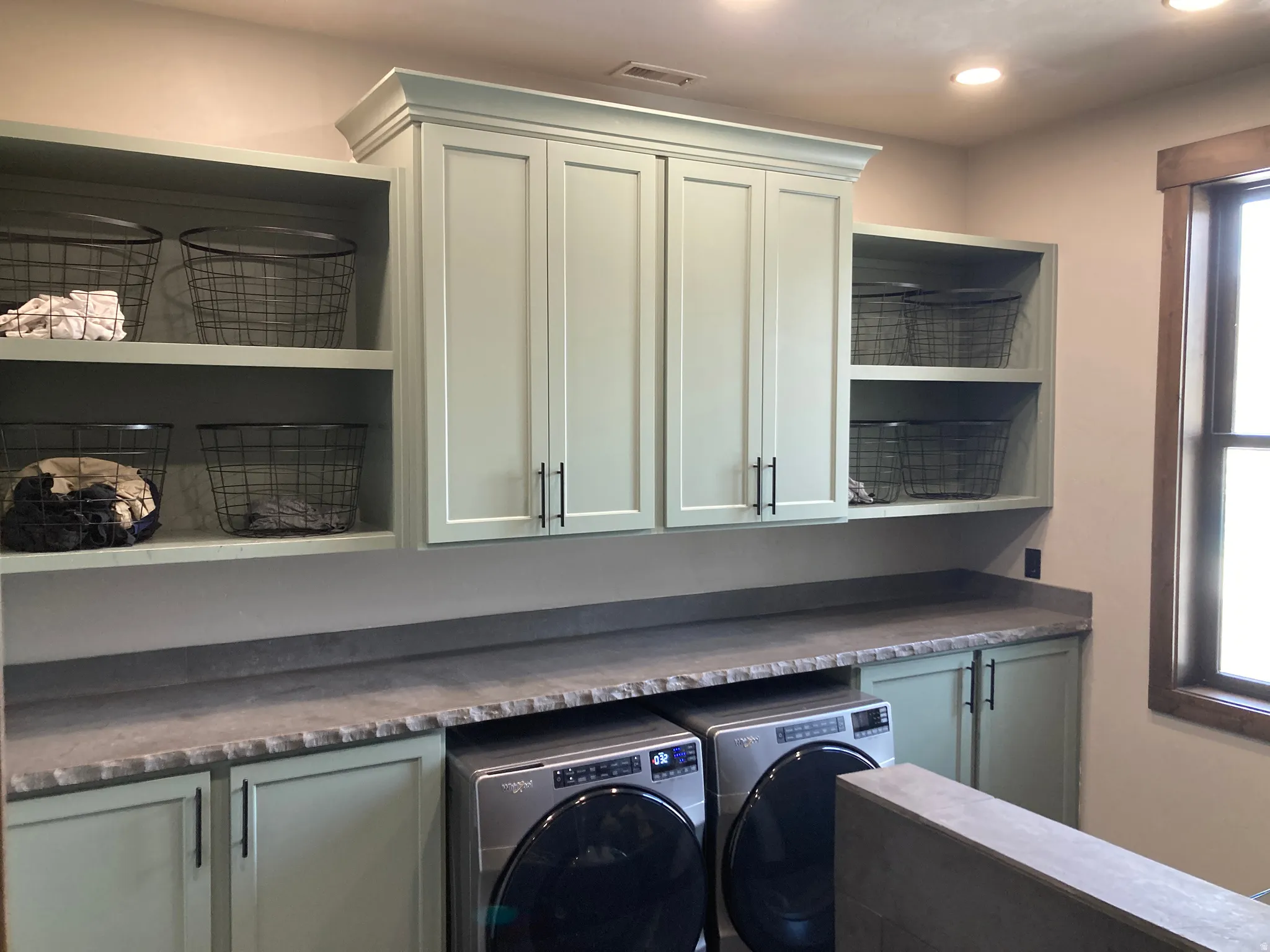 Laundry area with cabinet space, washer and clothes dryer, and recessed lighting
