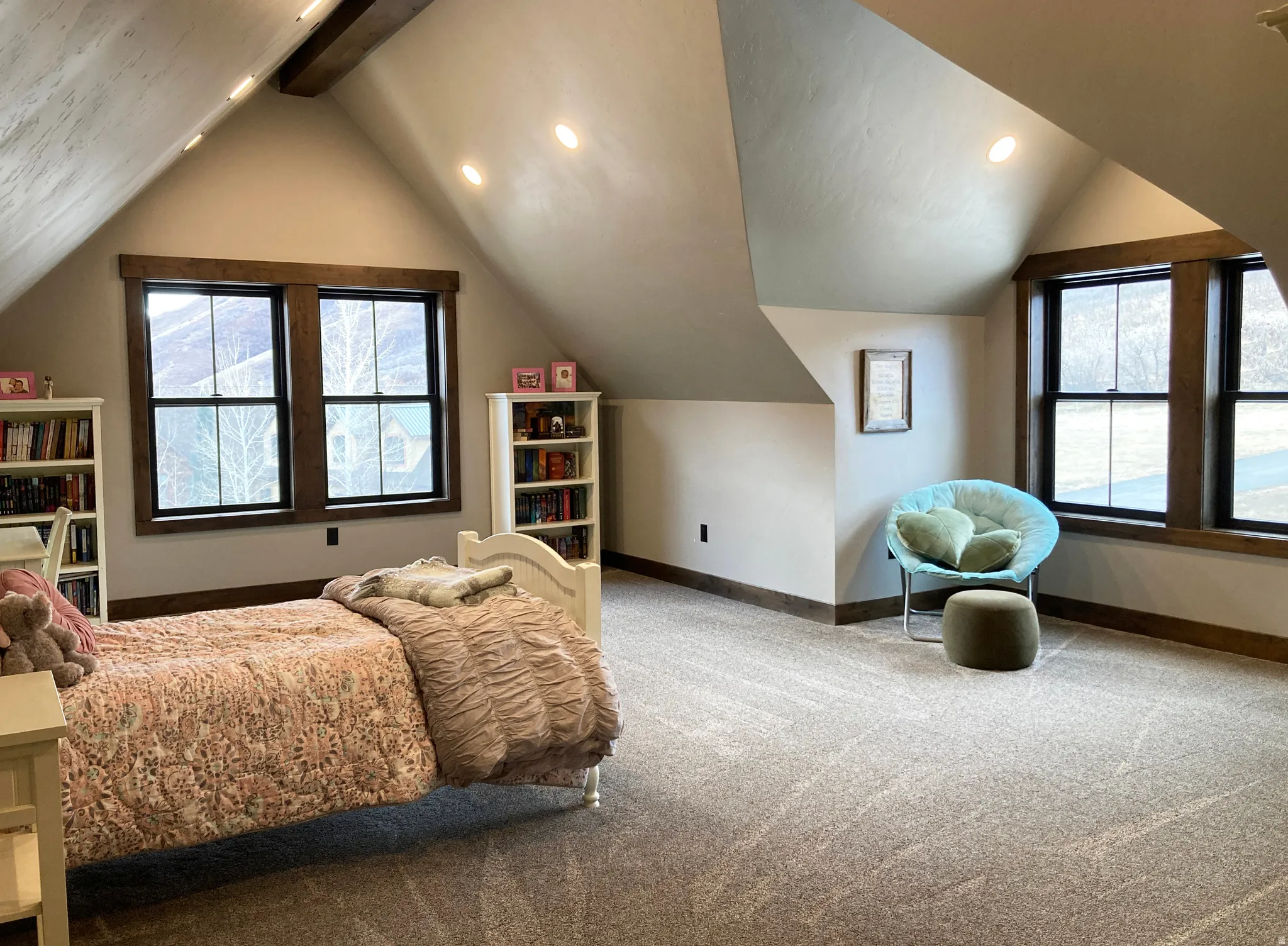 Carpeted bedroom with multiple windows and recessed lighting