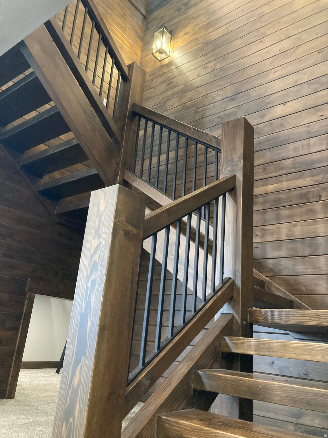 Stairway featuring wood walls and wooden ceiling