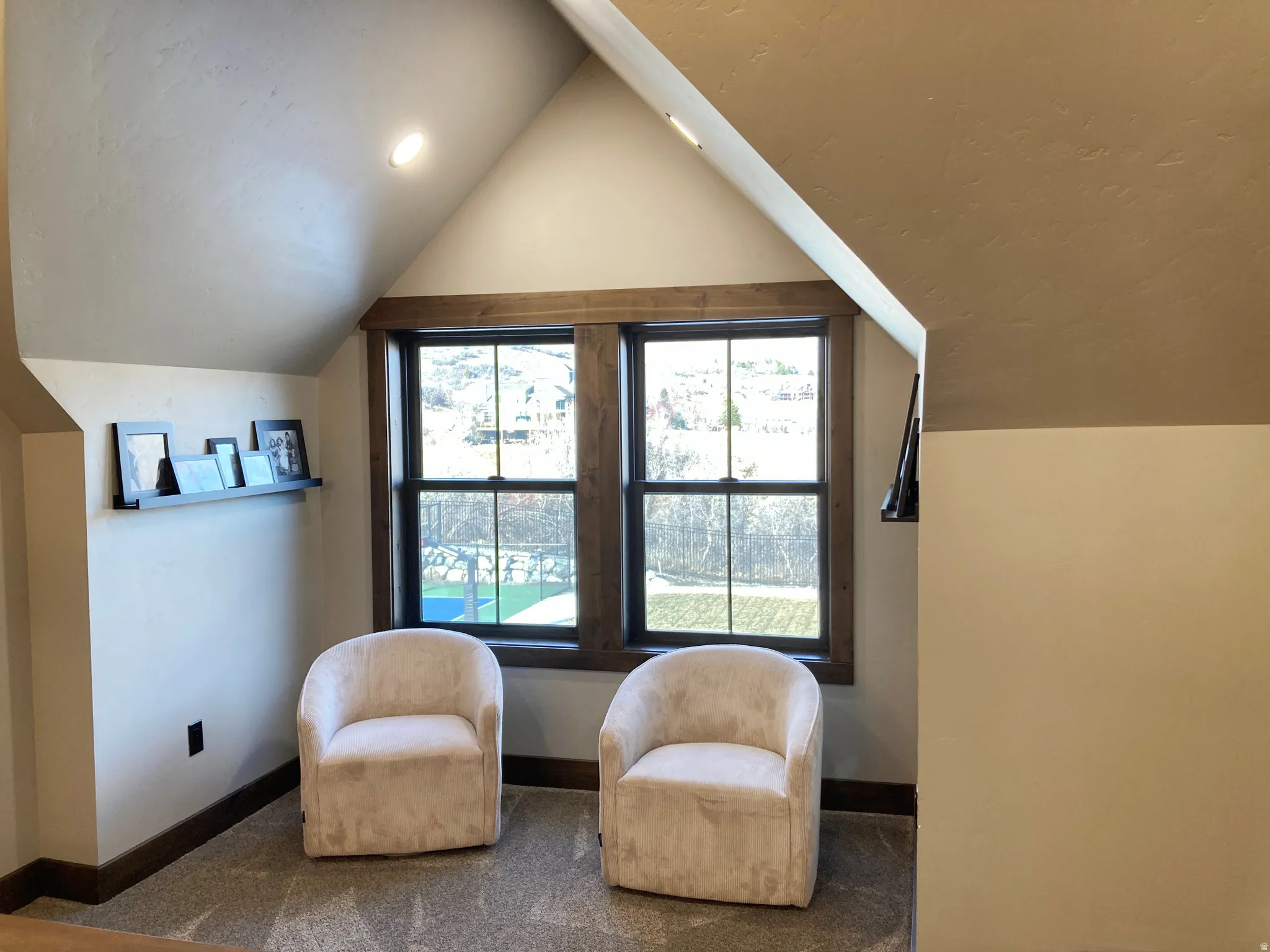 Living area with plenty of natural light and lofted ceiling