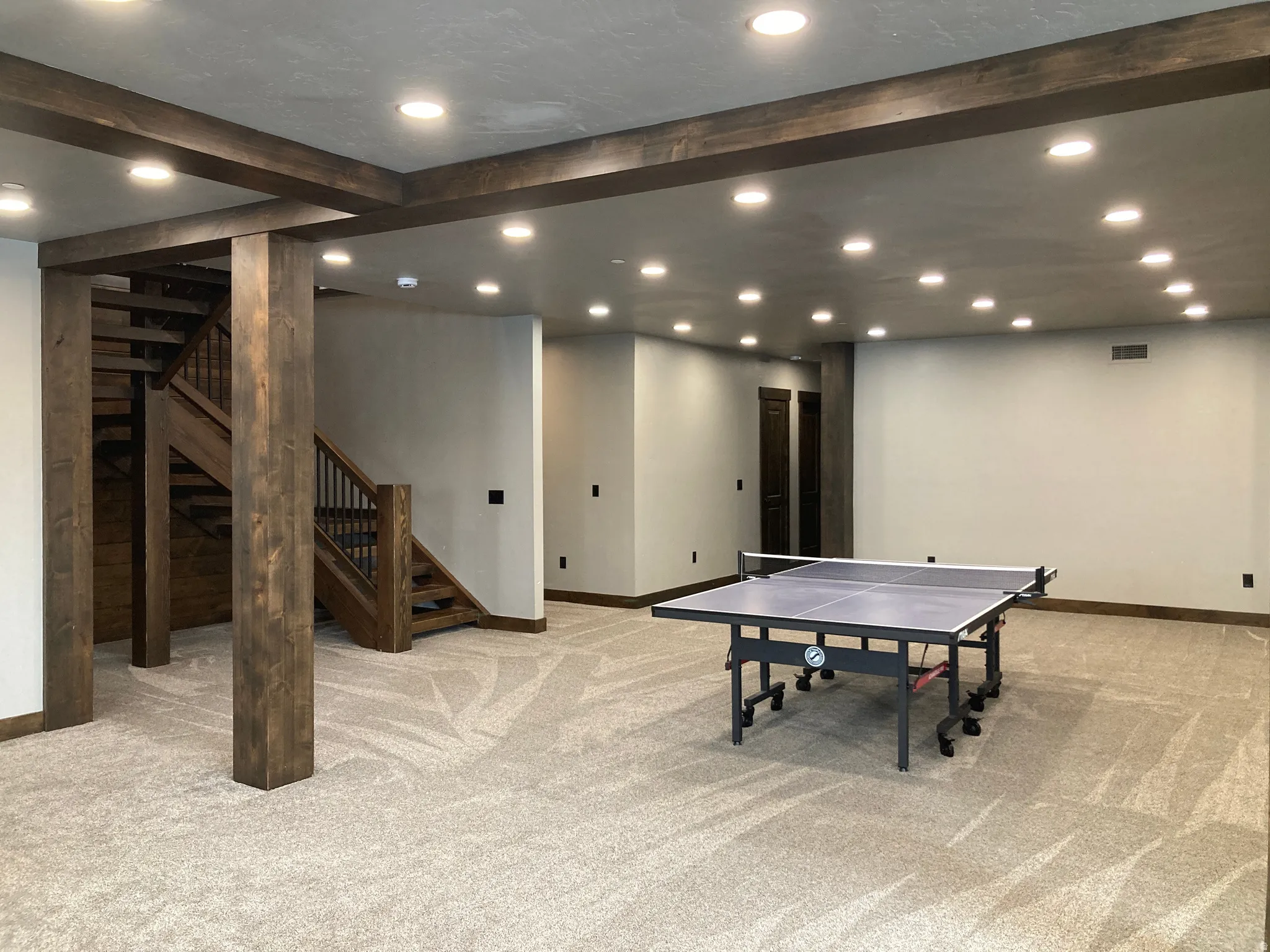 Rec room featuring light colored carpet, recessed lighting, and beam ceiling