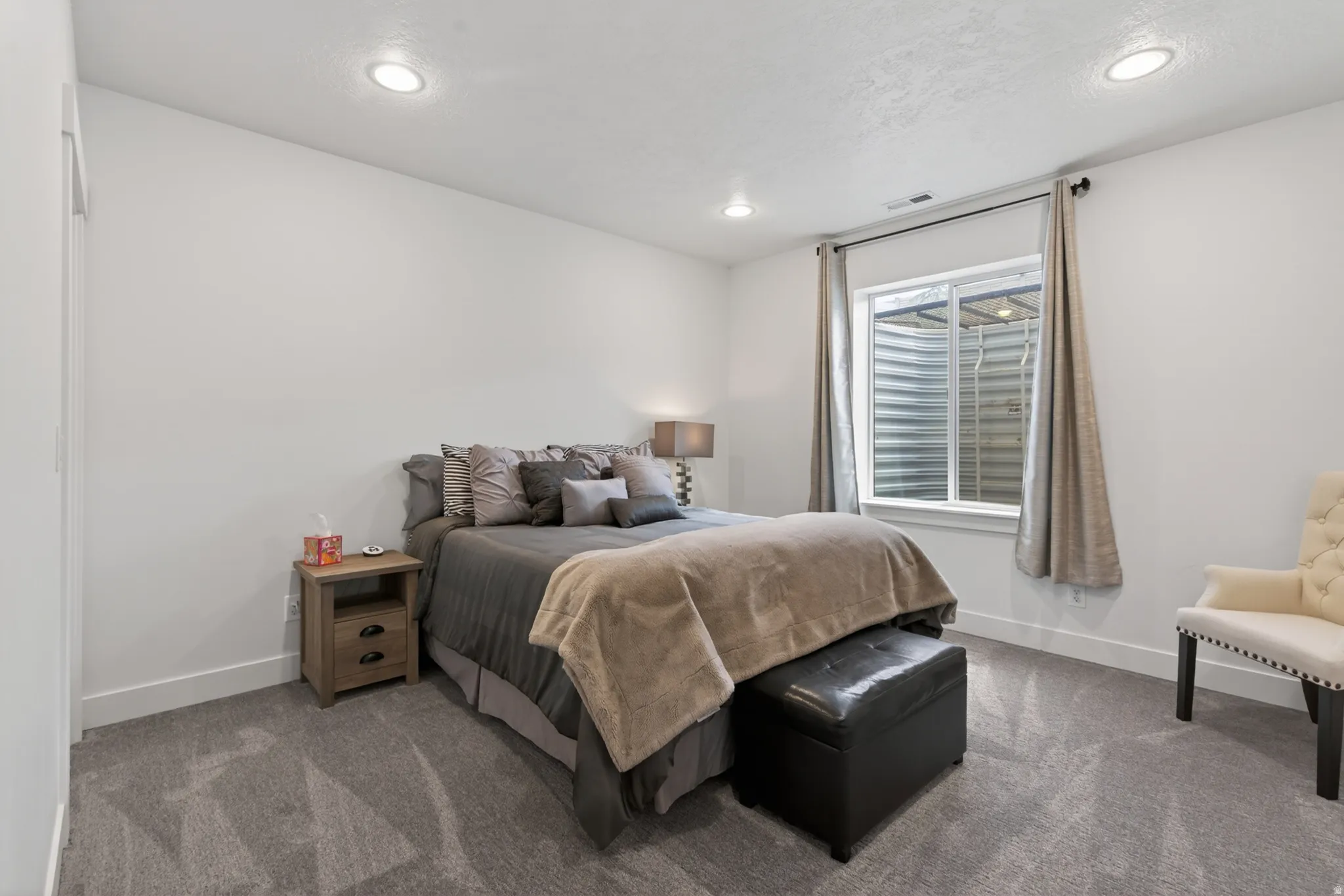 Carpeted bedroom with baseboards and recessed lighting