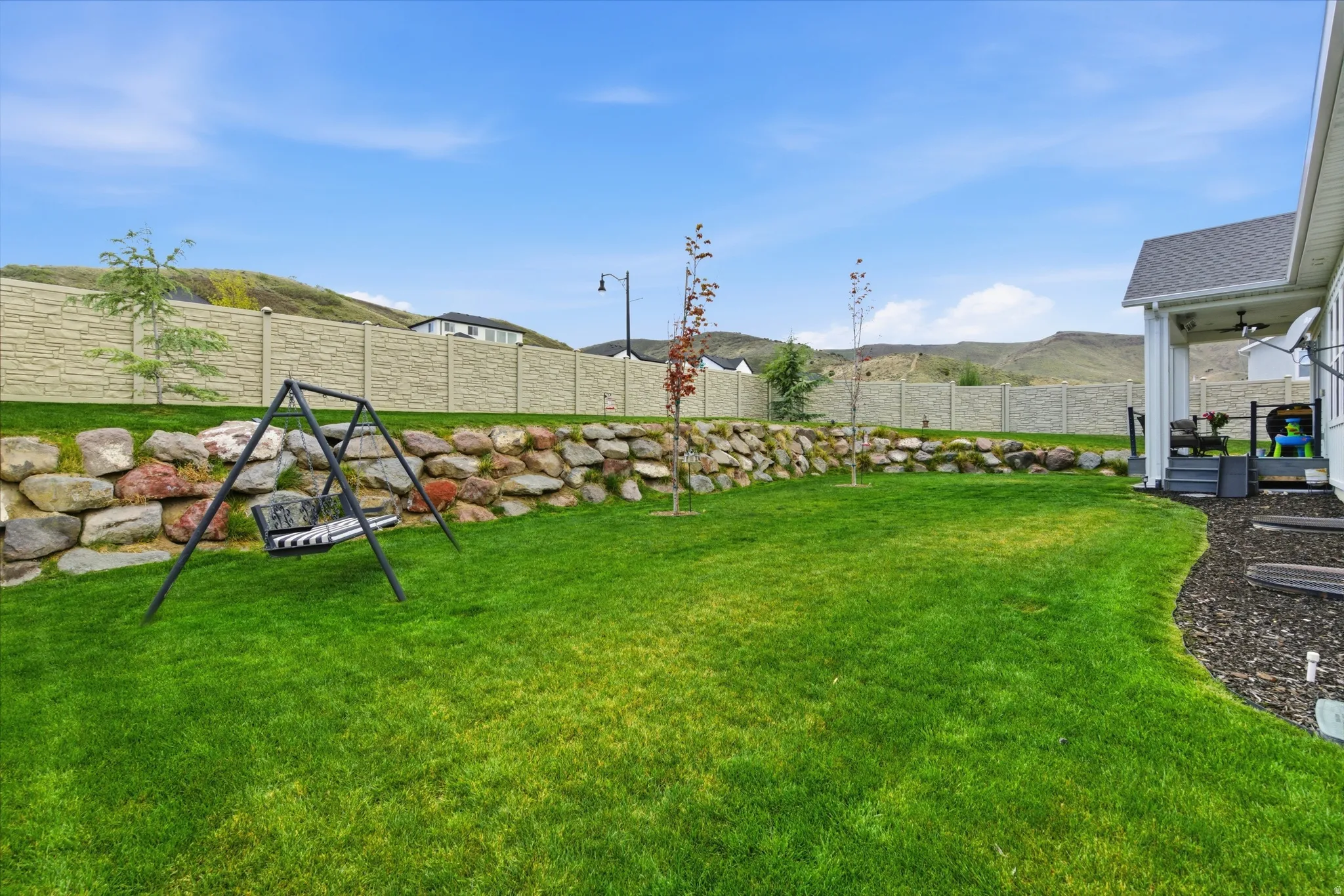 Fenced backyard with a mountain view and a patio area
