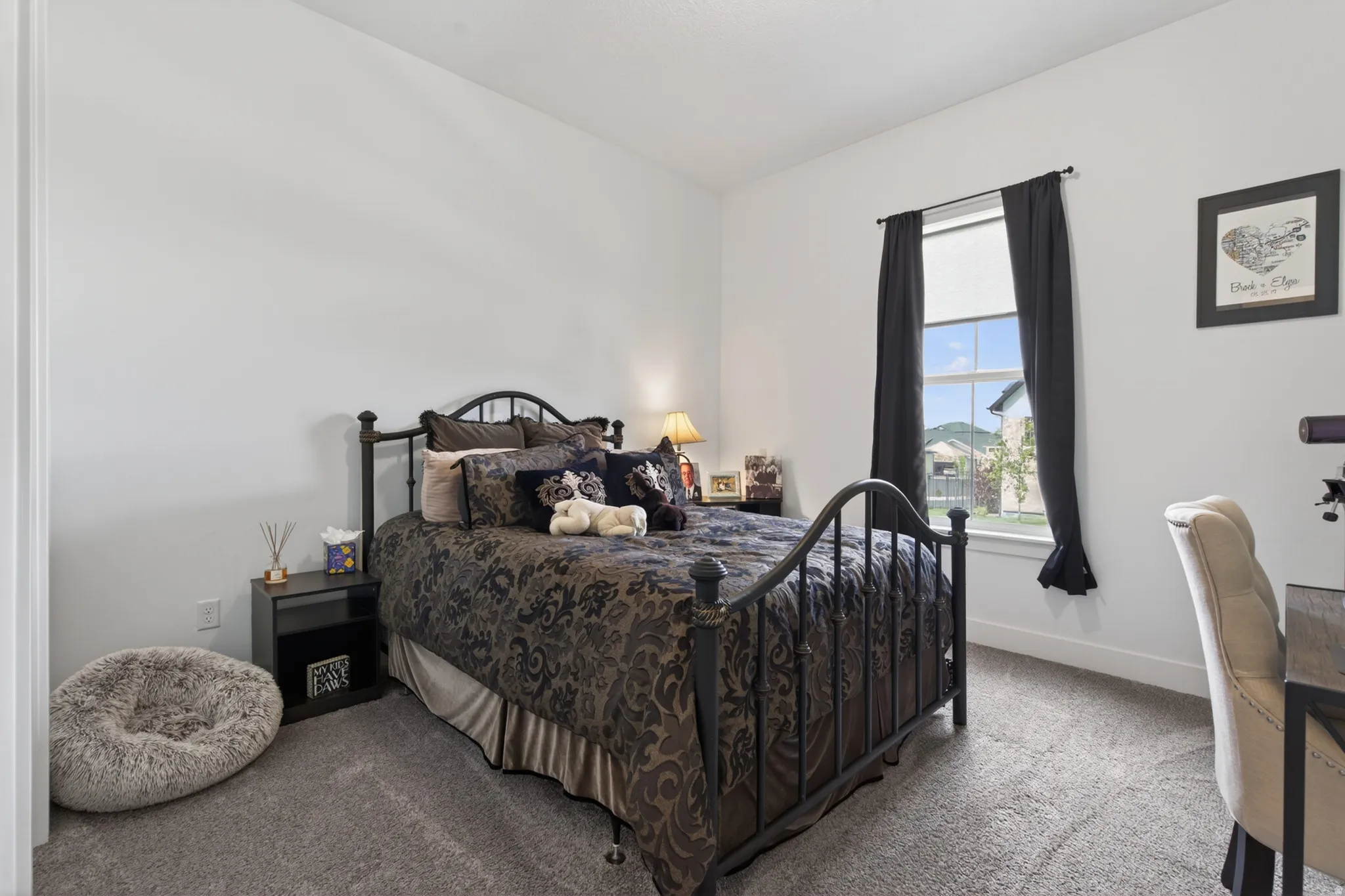 Bedroom featuring carpet floors and baseboards