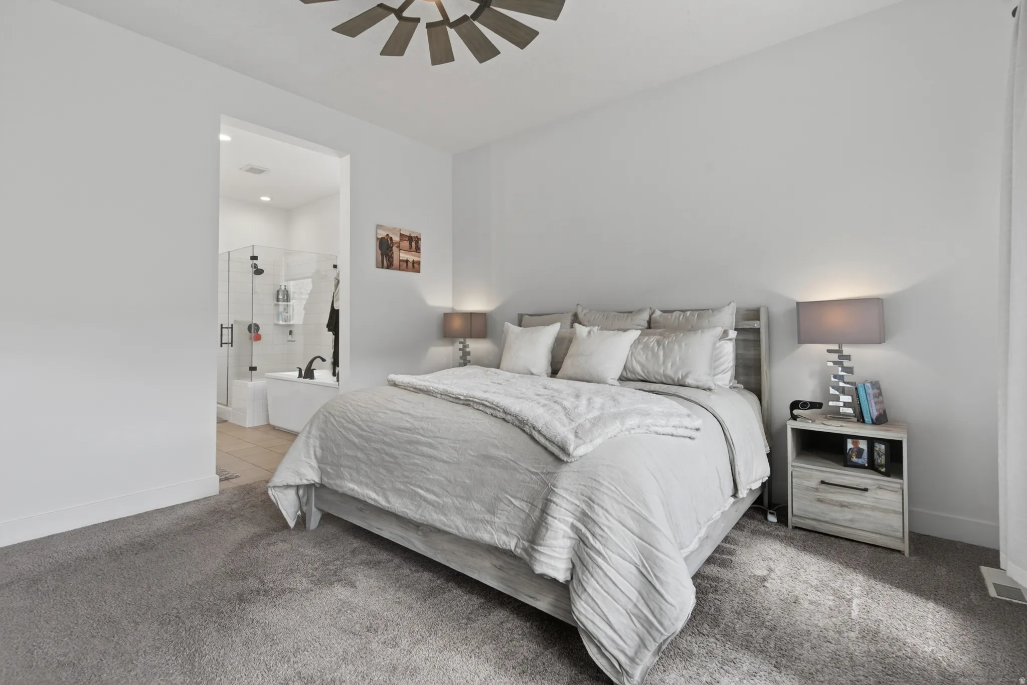 Carpeted bedroom featuring baseboards and ceiling fan