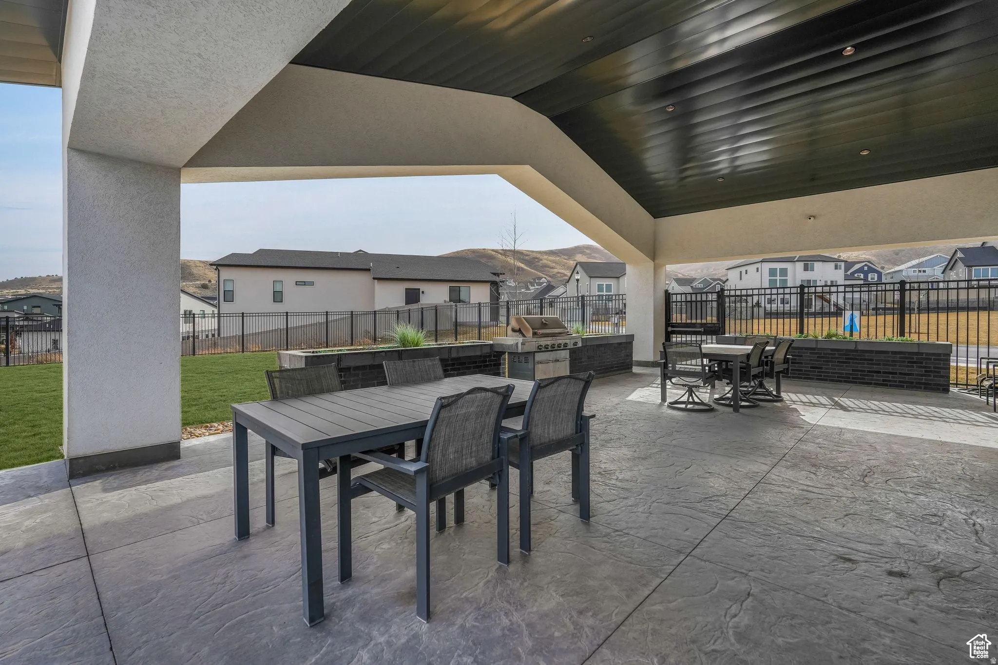 View of patio featuring outdoor dining space, a residential view, and grilling area