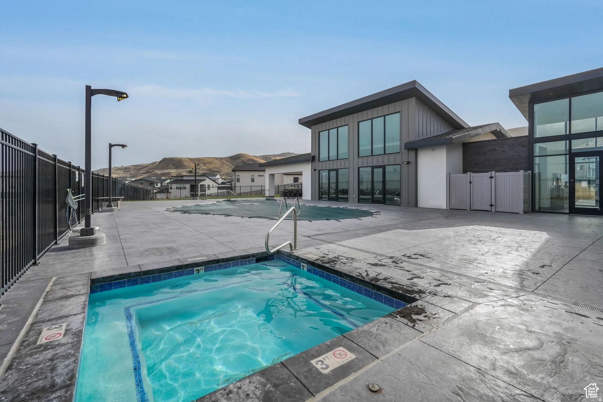 Community pool featuring a patio area and a hot tub