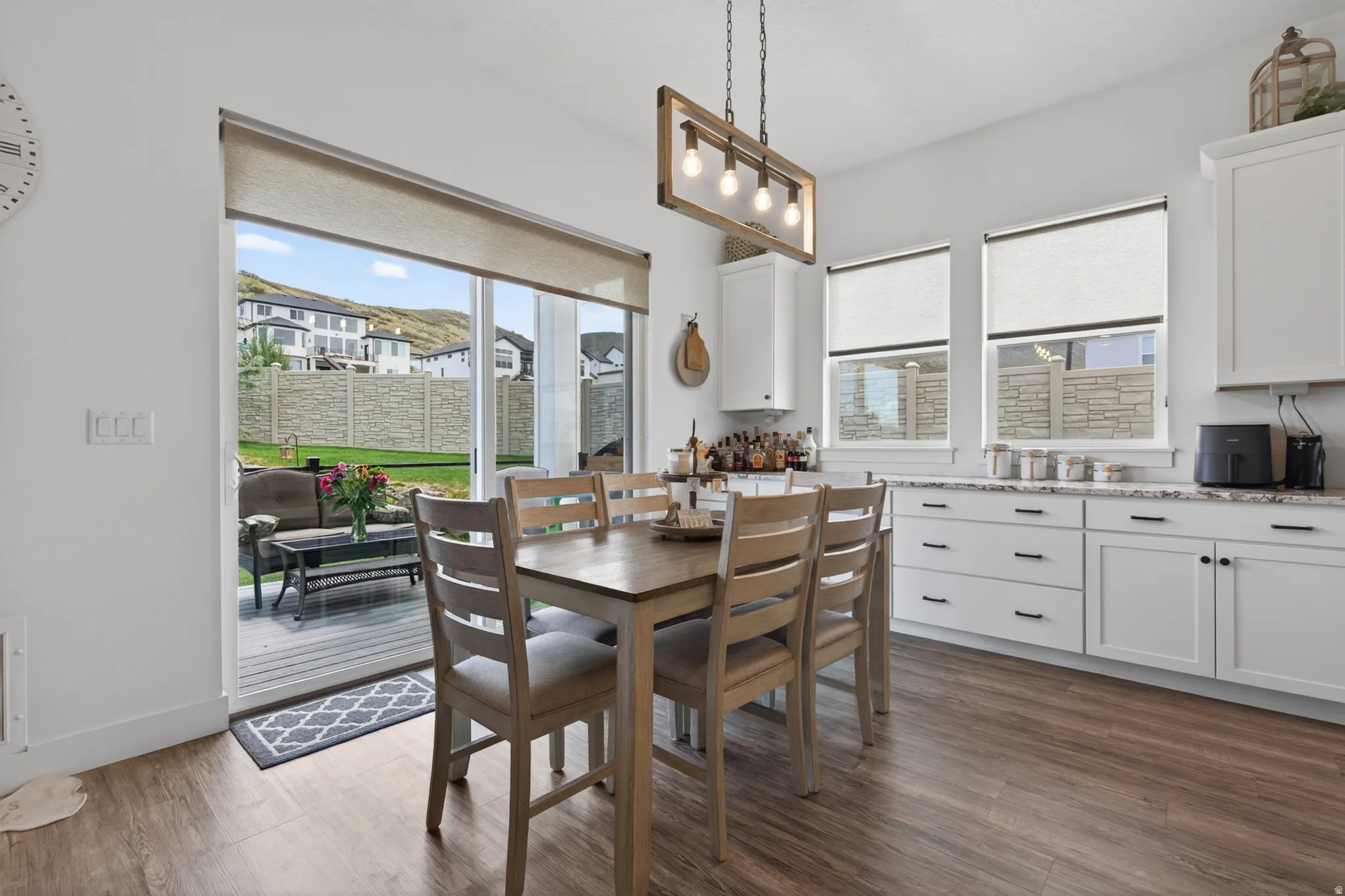 Dining area with dark wood-type flooring and baseboards