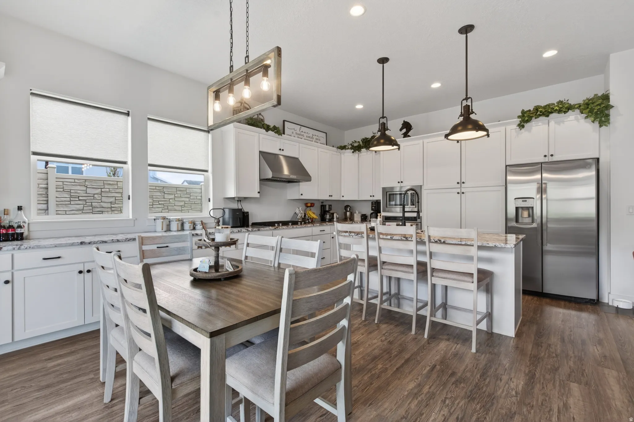Dining area featuring dark wood finished floors and recessed lighting