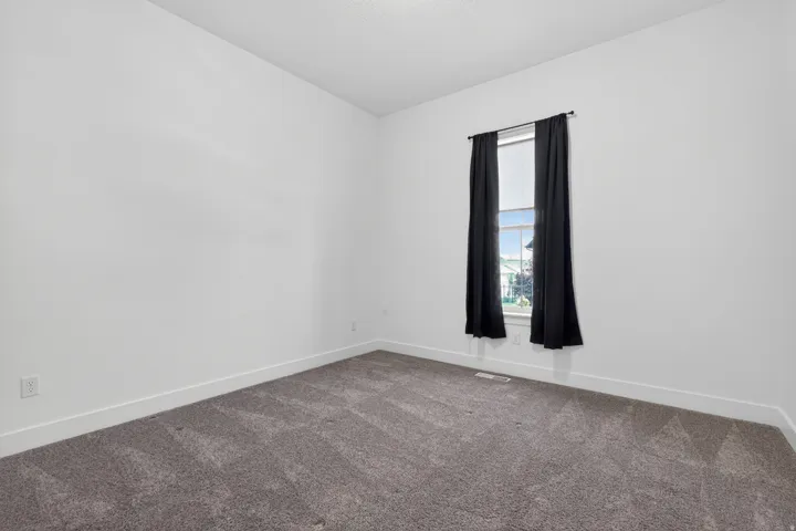 Neutral-toned wall paint with coordinating textured carpet flooring
