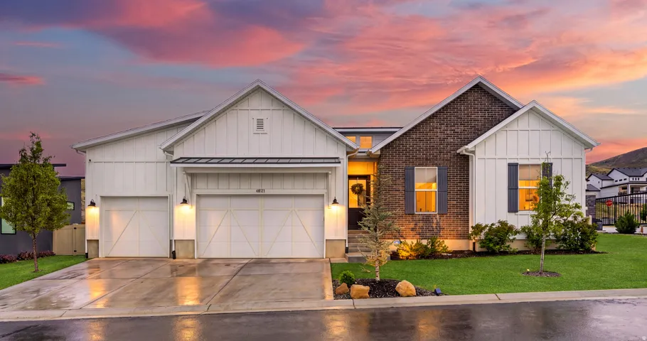 Contemporary exterior featuring board and batten siding and brick accents