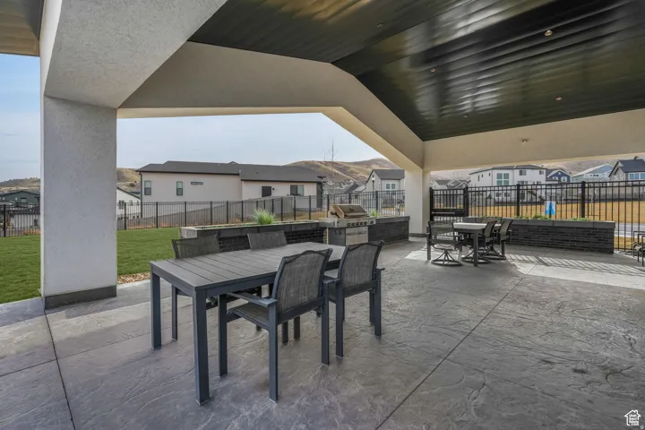 View of patio featuring outdoor dining space, a residential view, and grilling area