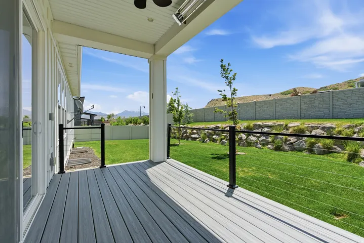 Covered porch with wood-finish decking and black cable railing