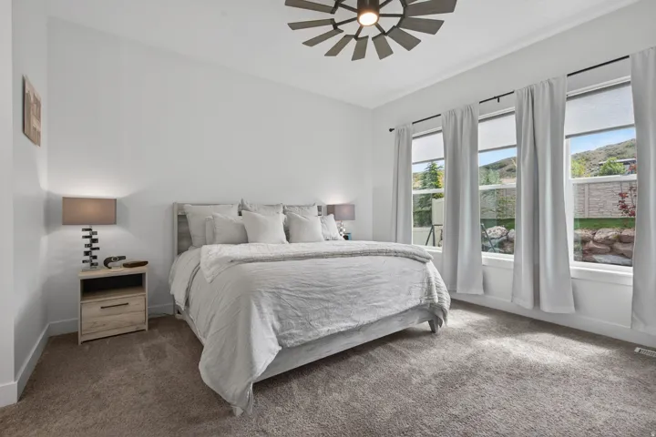 Spacious room featuring multiple large windows, recessed lighting, and a modern ceiling fan