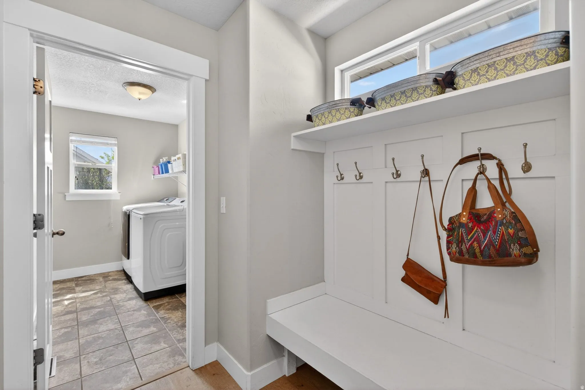 Mudroom with washing machine and clothes dryer and a textured ceiling