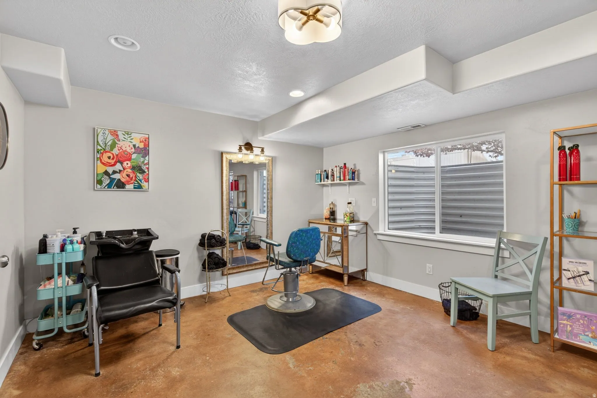 Sitting room featuring concrete floors, a textured ceiling, and recessed lighting