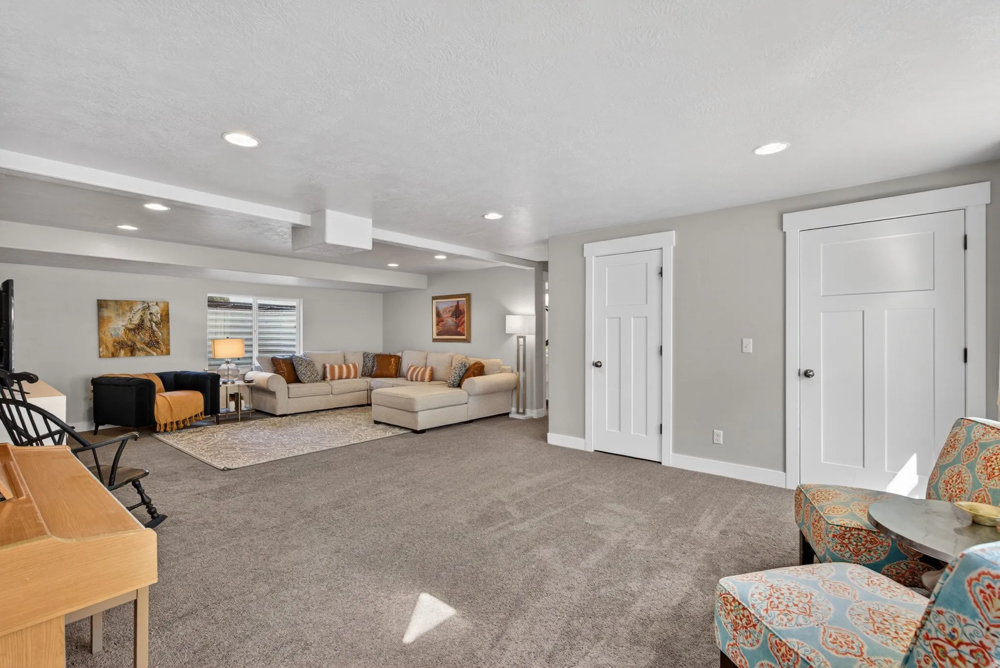 Carpeted living room with recessed lighting