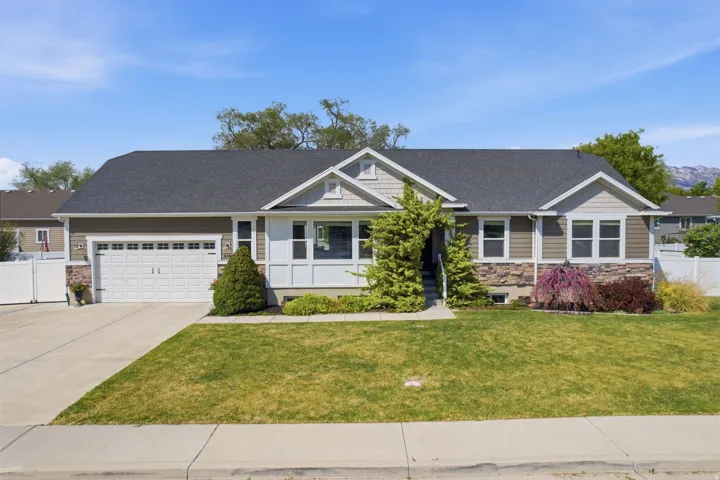 Craftsman inspired home with stone siding, an attached garage, concrete driveway, a shingled roof, and a porch
