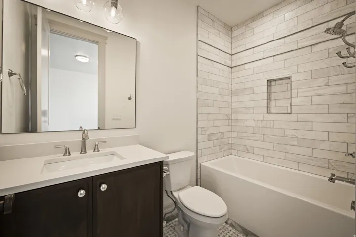Bathroom featuring vanity and  shower combination