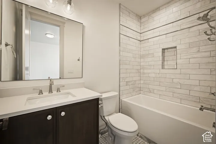 Bathroom featuring vanity and  shower combination