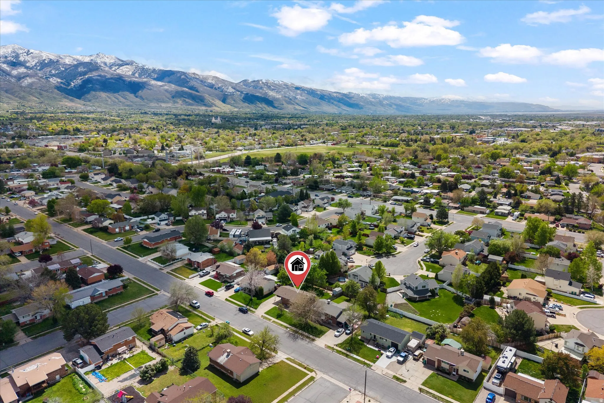 Aerial perspective of suburban area featuring a mountainous background
