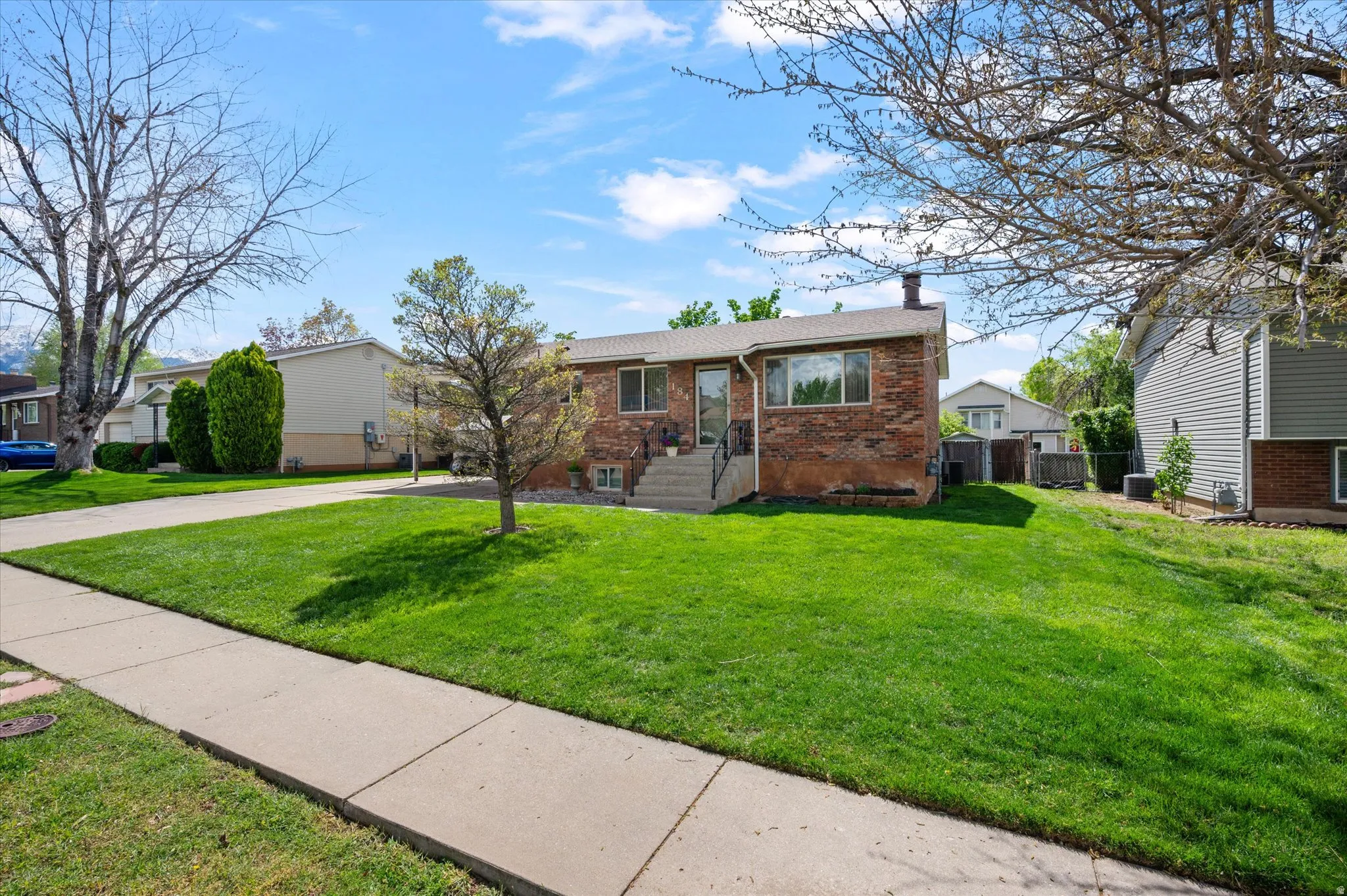 View of front of property featuring brick siding and a chimney