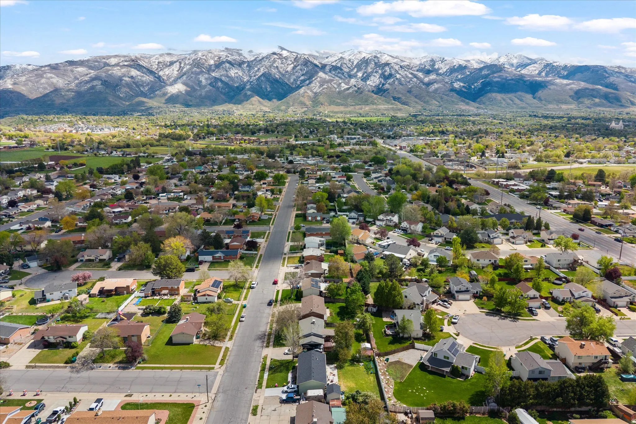 Aerial perspective of suburban area with mountains and property parcel outlined