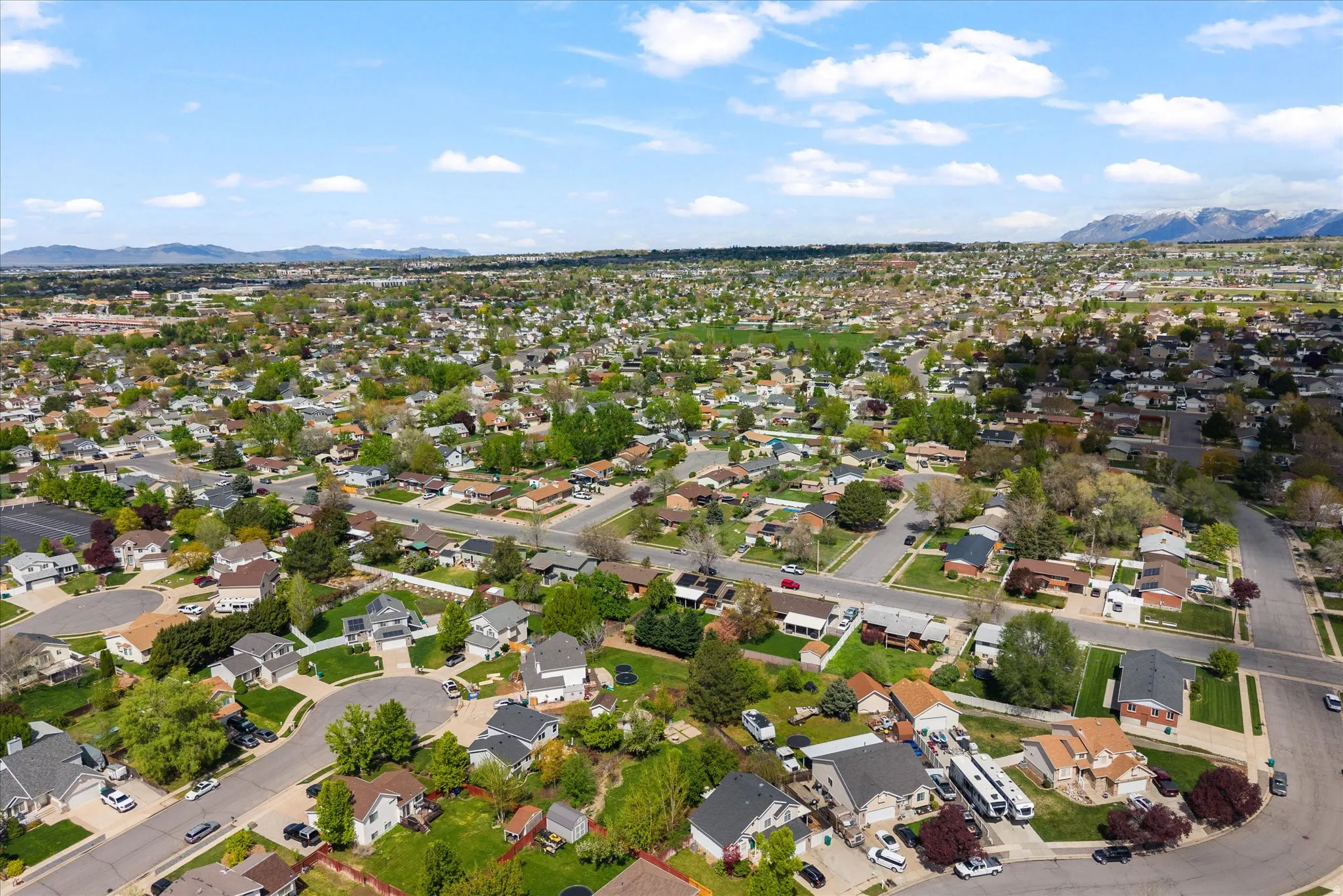 Aerial perspective of suburban area featuring a mountain backdrop