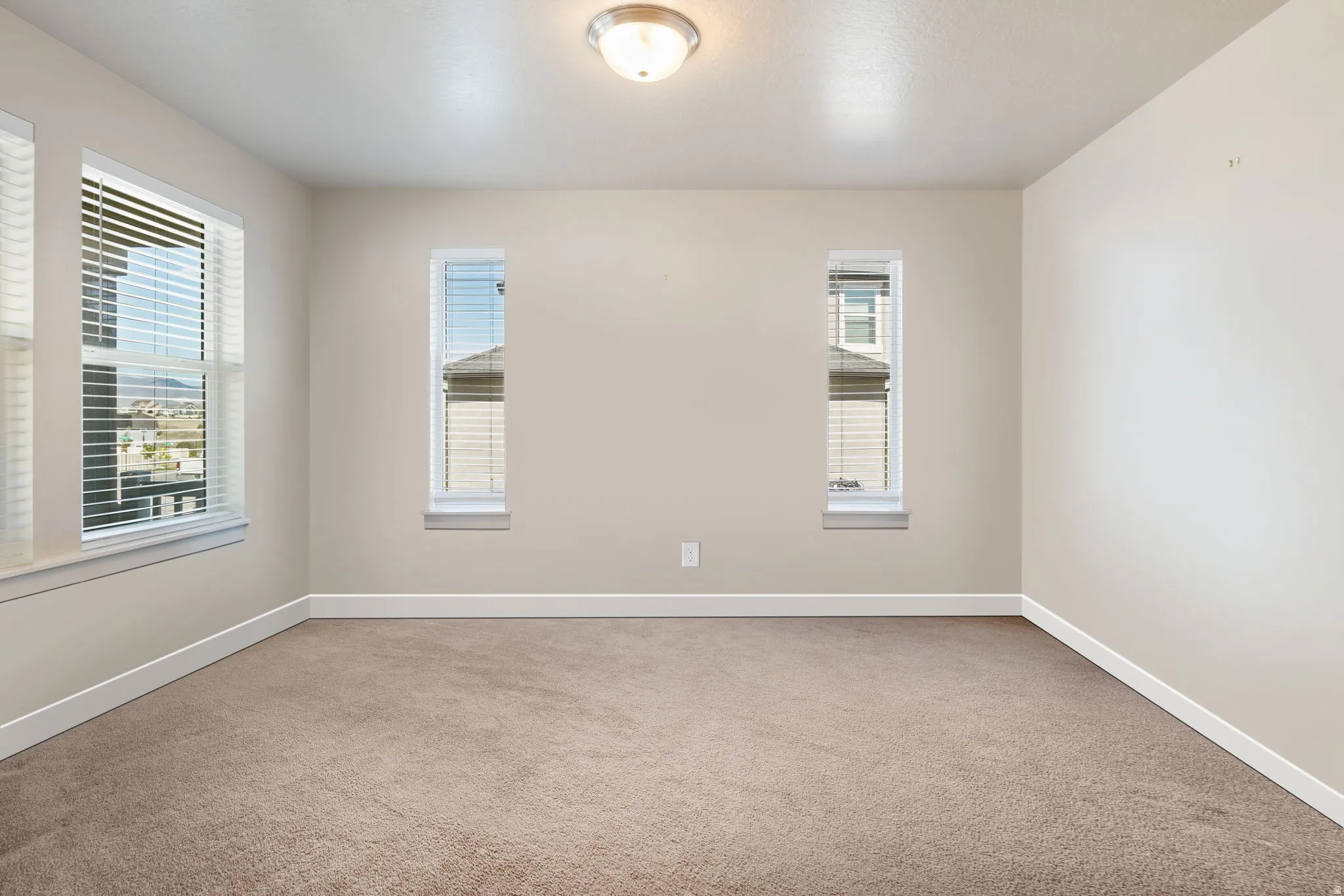 Unfurnished room featuring baseboards and carpet flooring