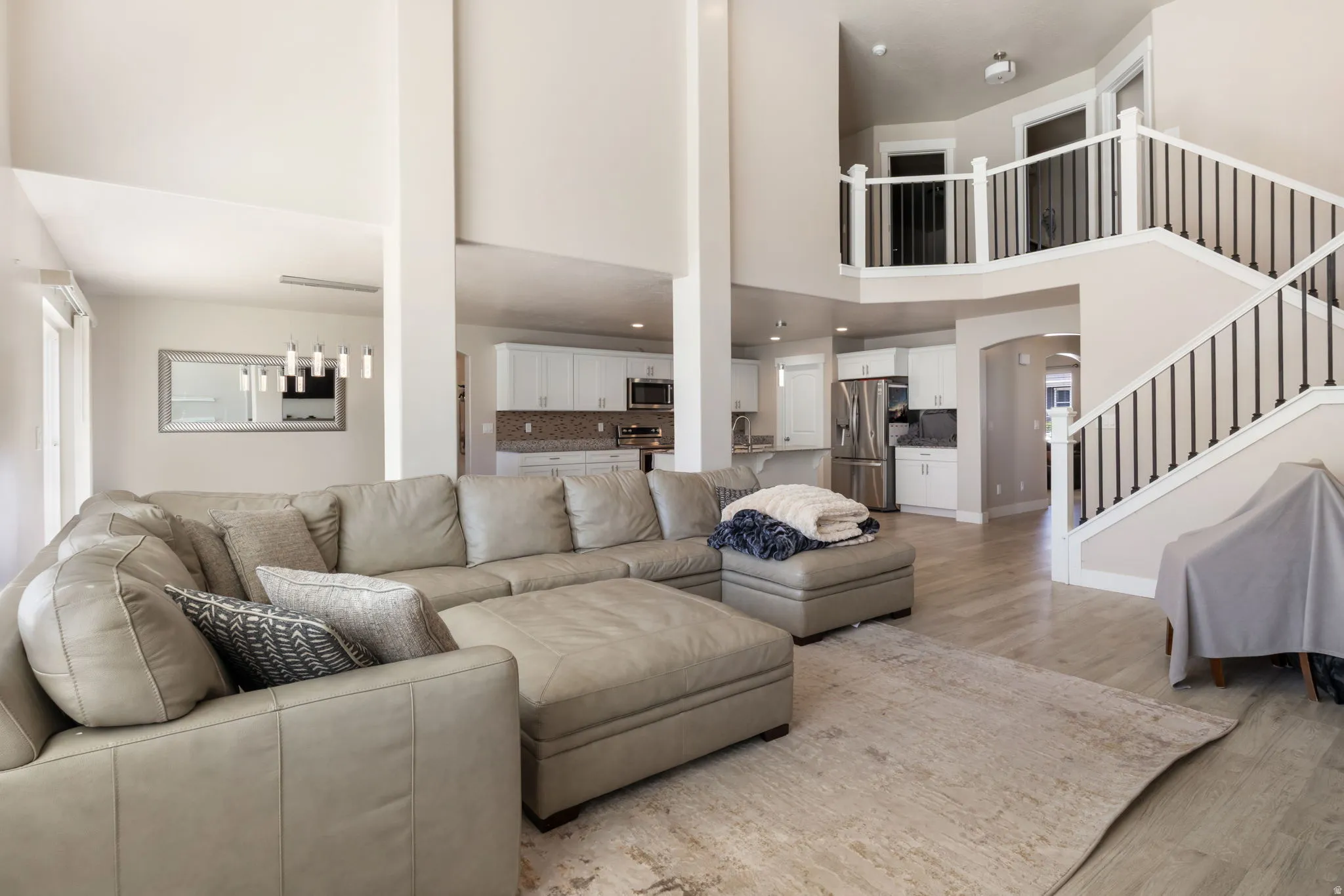 Living room featuring a high ceiling and light wood-type flooring