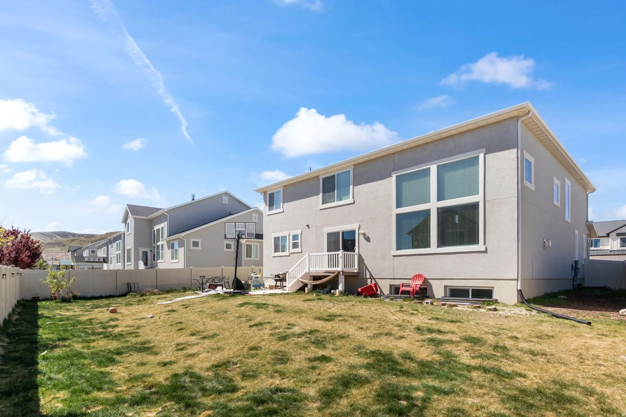 Back of house featuring a fenced backyard and stucco siding