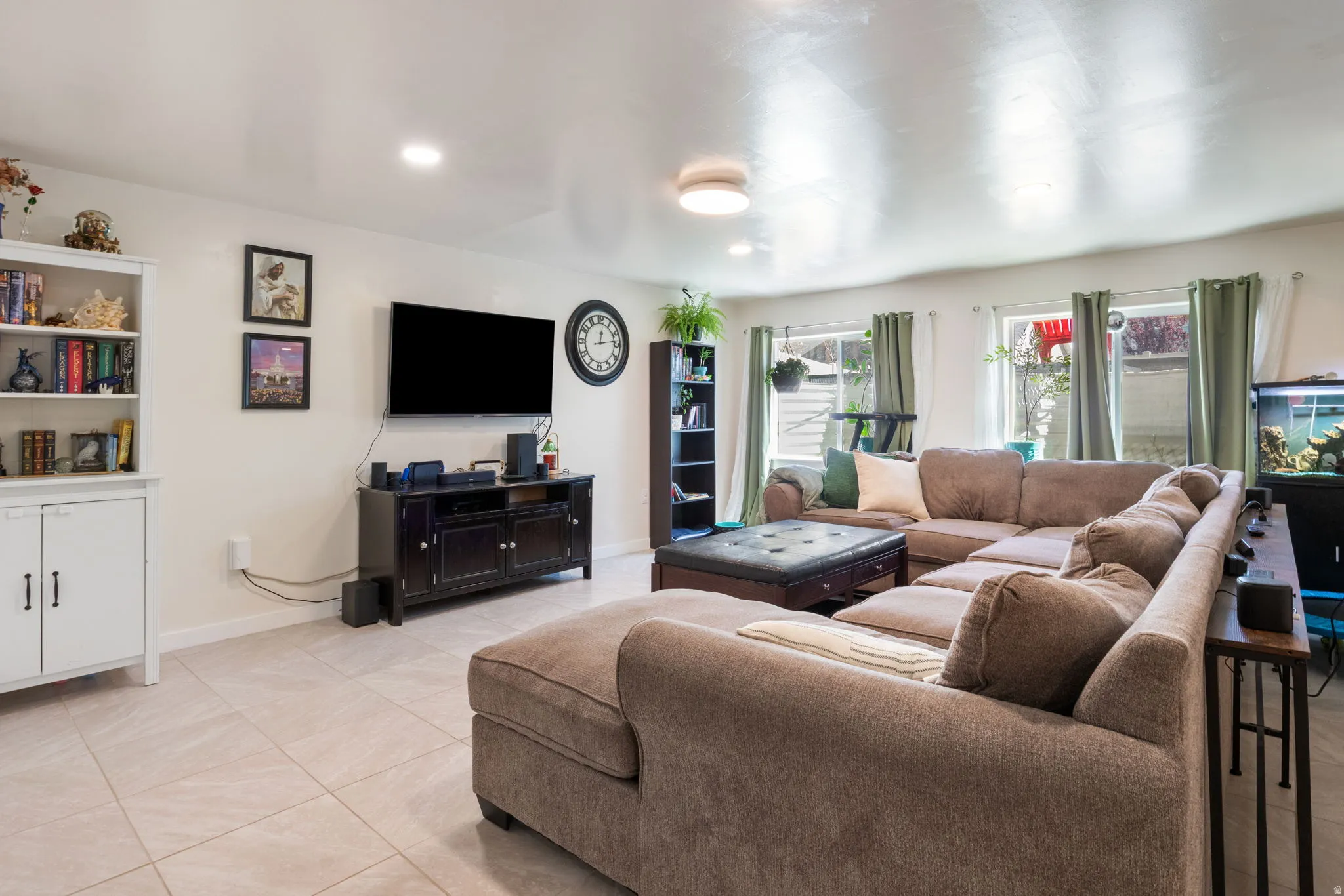 Living area with recessed lighting and light tile patterned floors
