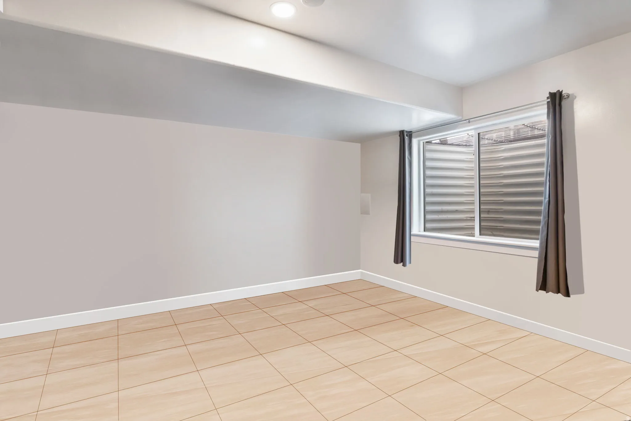 Unfurnished room featuring baseboards and light tile patterned floors