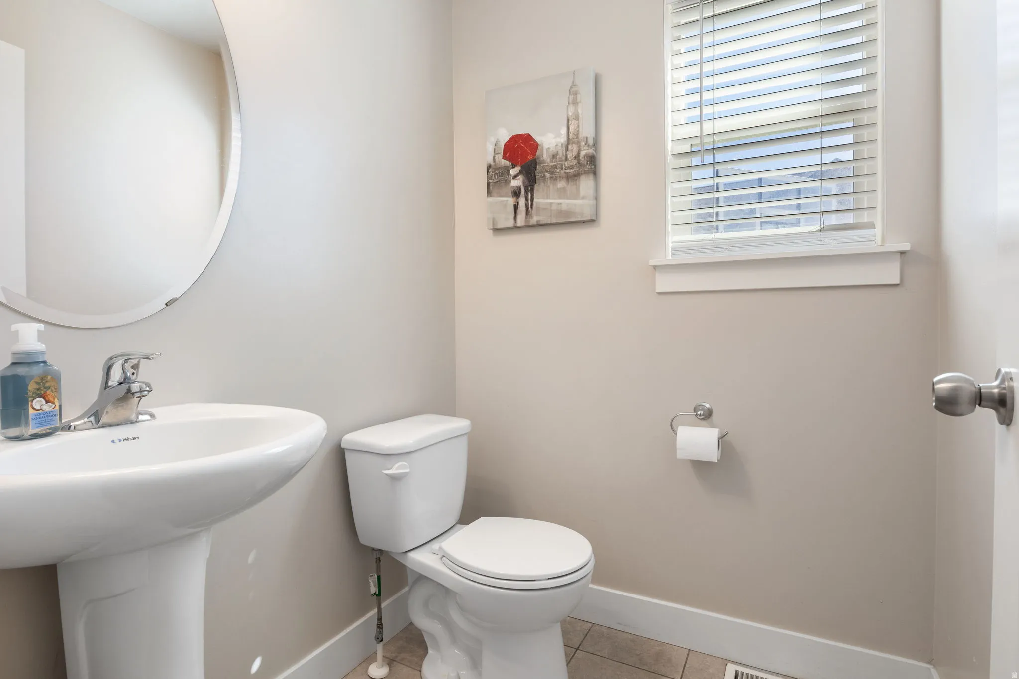 Half bath with toilet and light tile patterned flooring