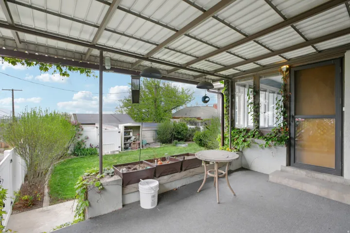 Sunroom featuring a patio area