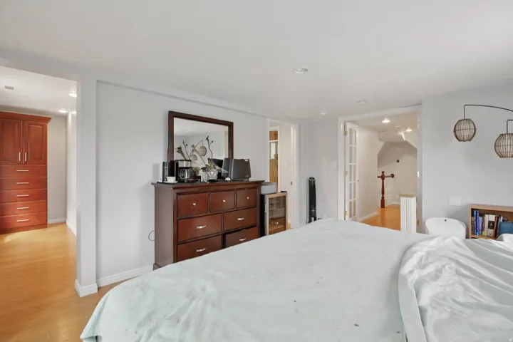 Bedroom with light wood-style floors and recessed lighting