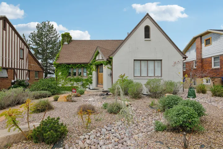 Tudor house featuring stucco siding and a shingled roof