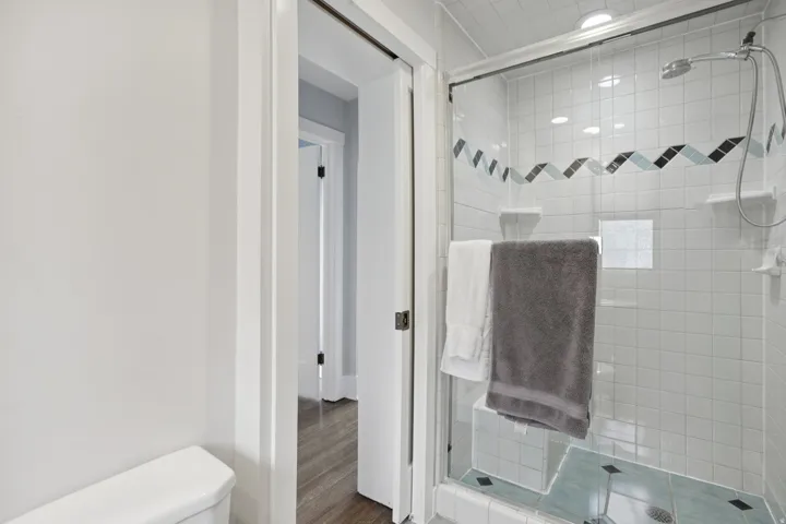 Bathroom featuring a stall shower and wood finished floors