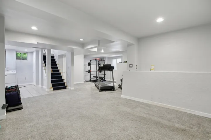 Exercise room featuring light colored carpet and recessed lighting