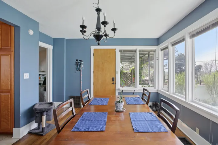 Dining space with suspended lighting and wood finished floors