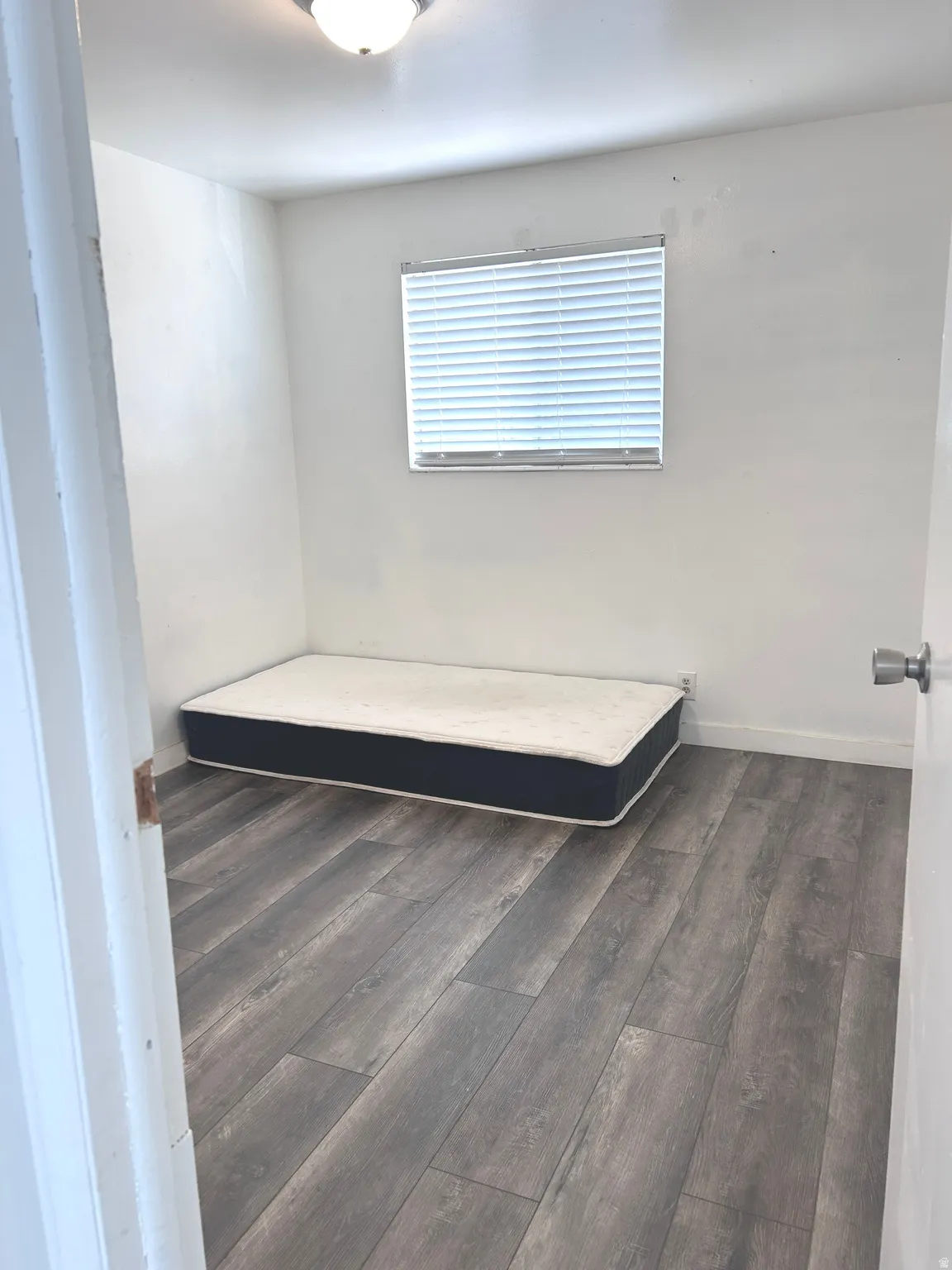 Bathroom featuring dark wood finished floors and baseboards