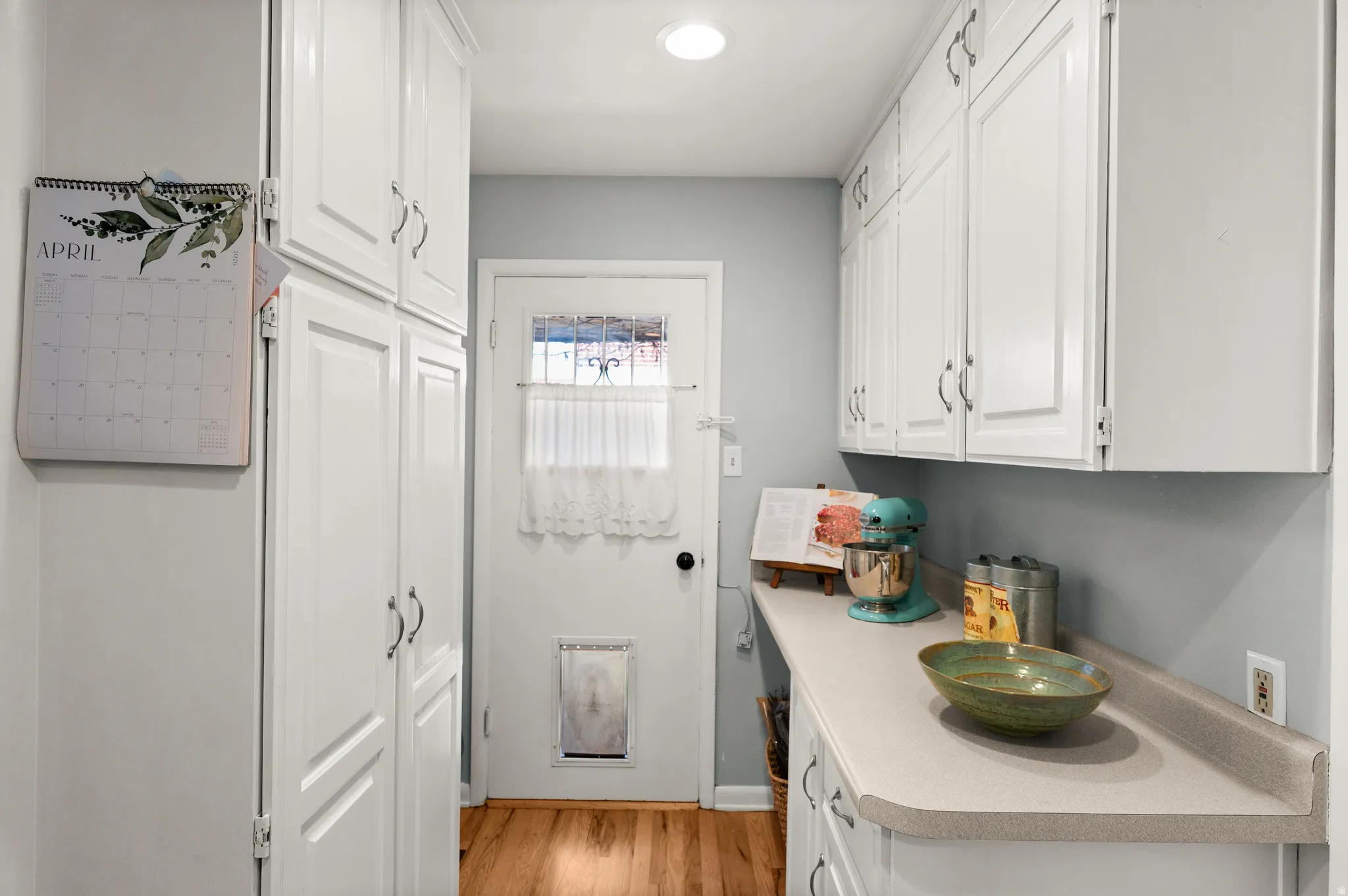 Super useful mud-room and pantry area off the kitchen with doors to the side yard and the garage
