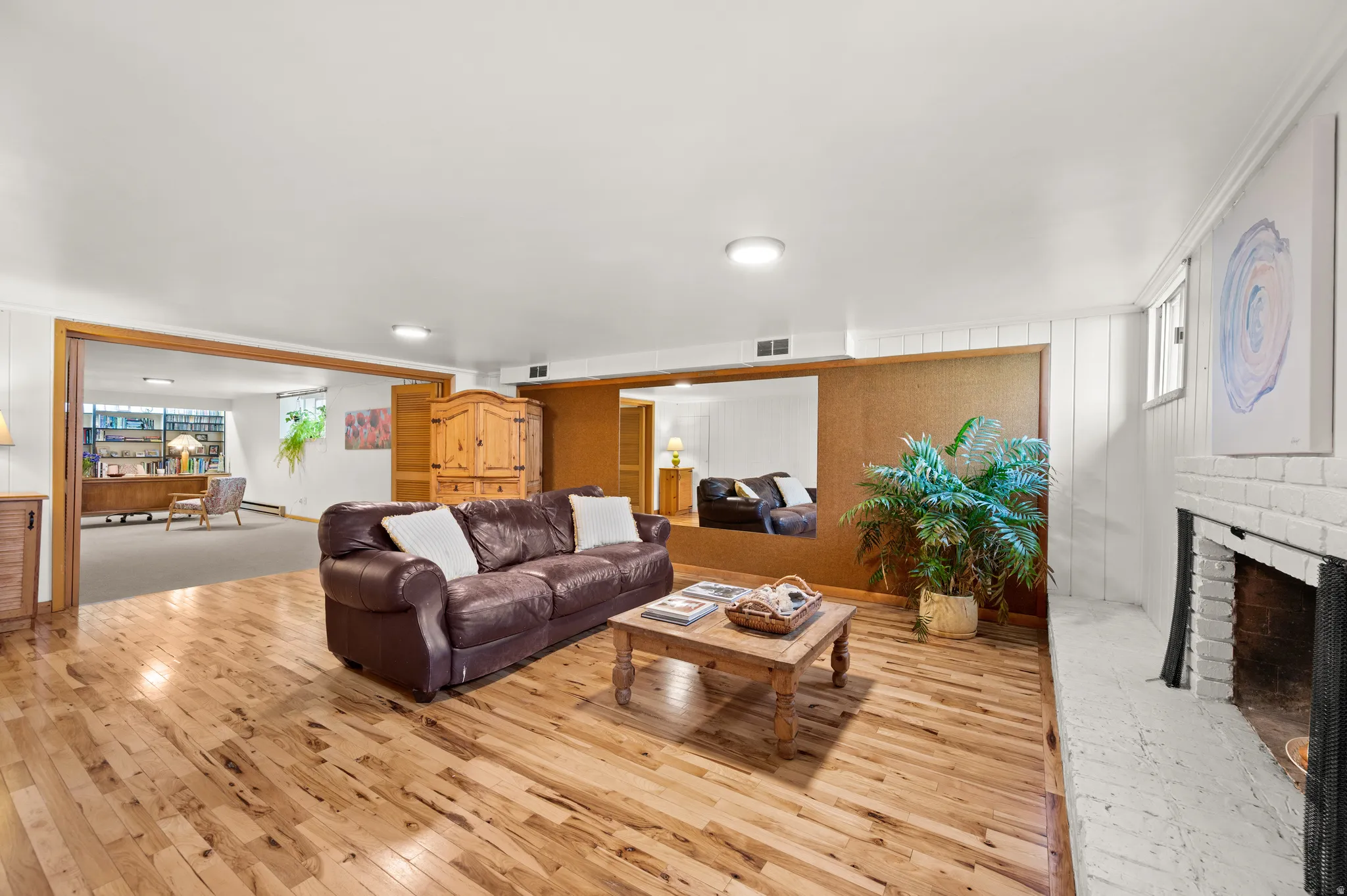 Downstairs family room with refinished hardwood floors