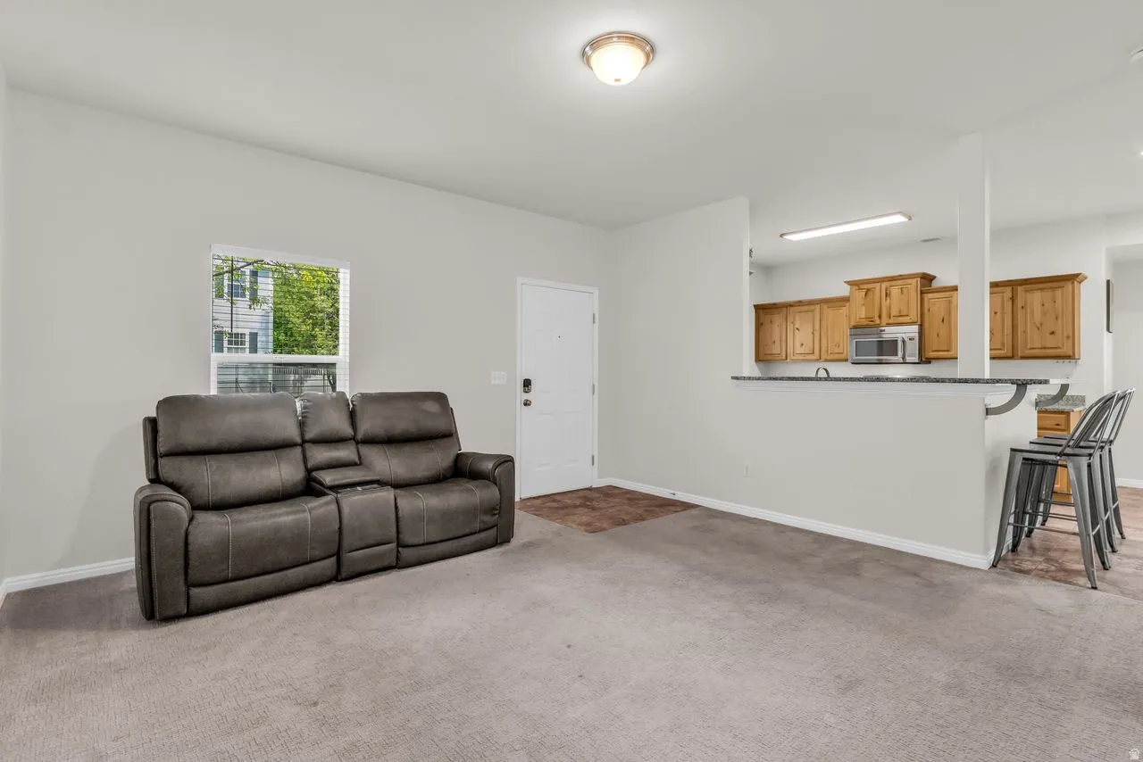 Living area featuring large window and tile entry